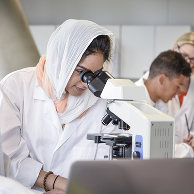 female researcher with microscope